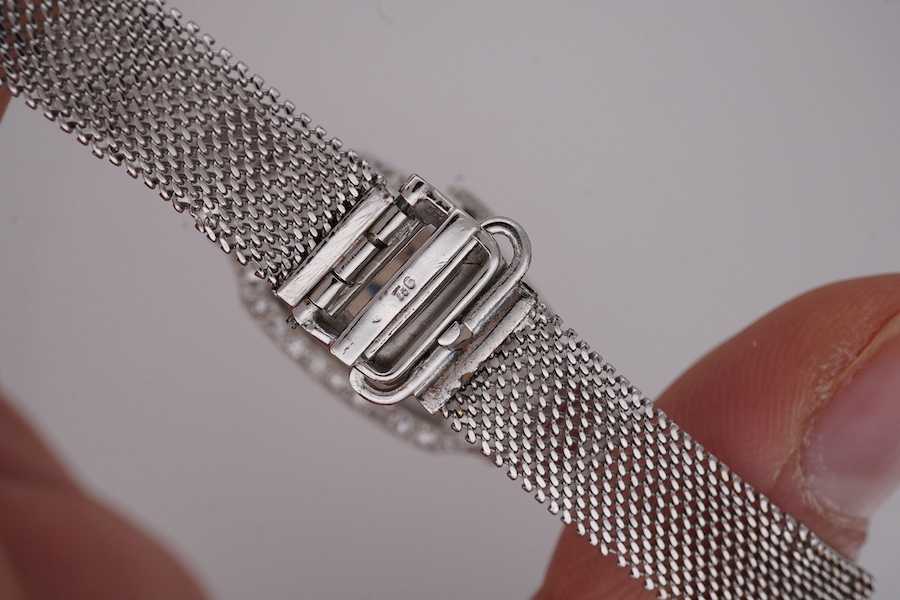 A lady's mid 20th century Swiss white metal(platinum mark) and diamond set cocktail watch with 'tumbling' Arabic numeral dial, on a 9ct white metal mesh link bracelet, case diameter 16mm, overall length 16cm, gross weigh